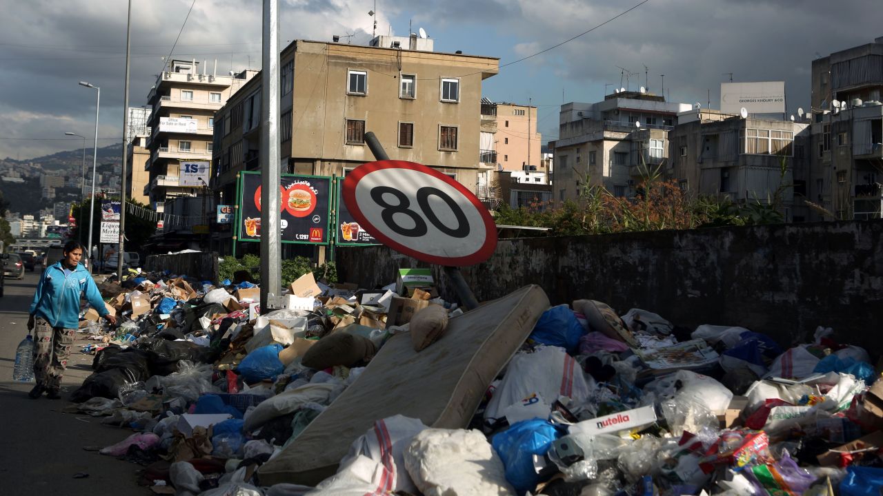 A traffic sign bends under the weight of garbage piling up on the side of a road north of the Lebanese capital on January 15.