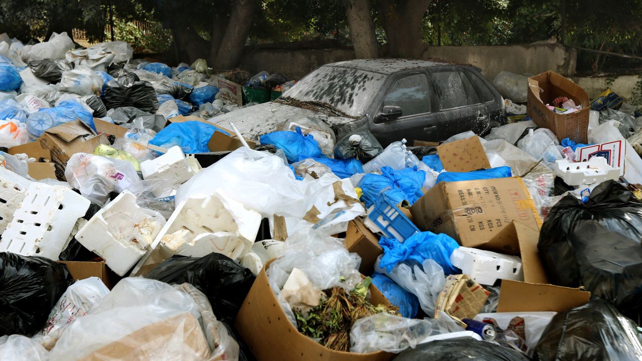 Garbage surrounds a car in Baabda, east of the Lebanese capital, on August 24.