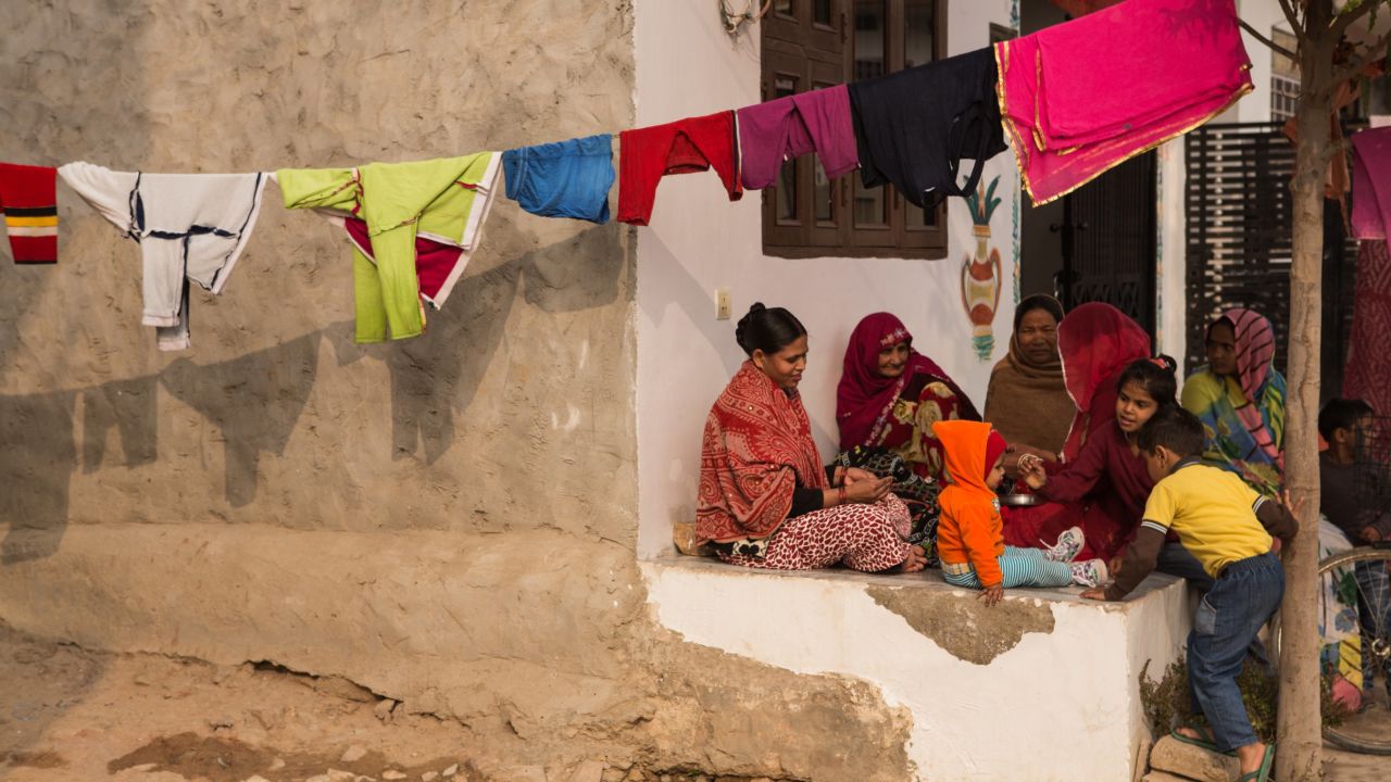 A young boy in Jaipur with his family. Many residents in the city are poor, and regular meals are scarce.