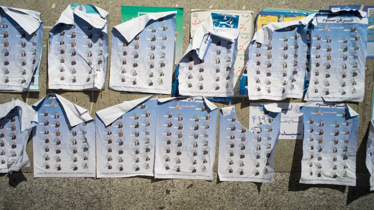 Pictures of candidates cover a wall in the country's capital.