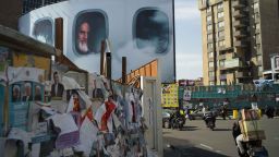 Lurking behind campaign posters is the country's first Supreme Leader, Ruhollah Khomeini, in a billboard commemorating his airborne return to Iran in 1979 after 14 years in exile.