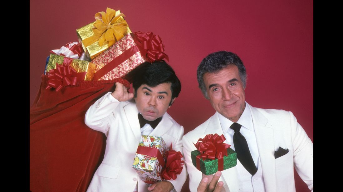 <strong>'Fantasy Island':</strong> Every week, ABC's "Fantasy Island" began the same way:  Tattoo, played by Herve Villechaize, left, would shout: "The plane! The plane!" Then, Mr. Roarke -- the mysterious island host played by Ricardo Montalban, right -- would remind his employees to welcome the guests with, "Smiles, everyone, smiles!" In a decade of excess, somehow it didn't seem far-fetched to believe in a place where wealthy people would pay huge amounts of money to play out their outlandish narcissistic fantasies. 