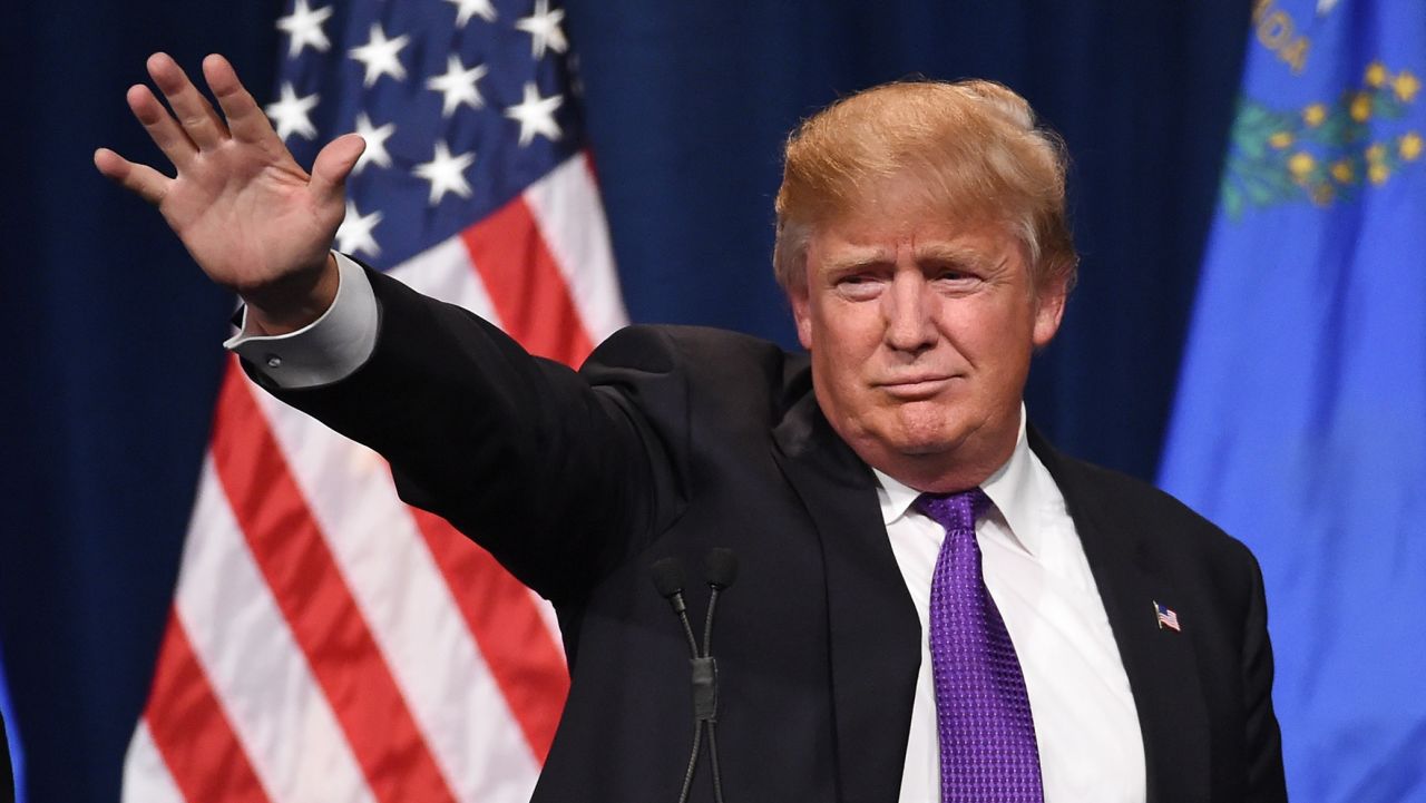 LAS VEGAS, NV - FEBRUARY 23:  Donald Trump Jr. (L) looks on as his father, Republican presidential candidate Donald Trump, waves after speaking at a caucus night watch party at the Treasure Island Hotel & Casino on February 23, 2016 in Las Vegas, Nevada. The New York businessman won his third state victory in a row in the "first in the West" caucuses.  (Photo by Ethan Miller/Getty Images)