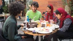 Young university students at the Tehranís cinema cafe. They're studying English literature ñ and very hopeful for their country's future.