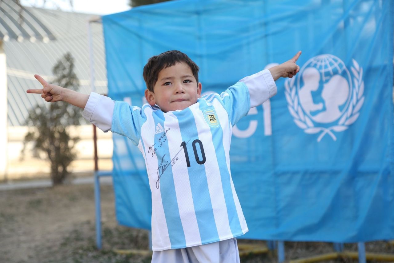 Murtaza wears the autographed Lionel Messi Argentina shirt given to him by the soccer superstar and UNICEF. He had been pictured in his native Afghanistan wearing a striped plastic bag with the star's name and number written on it to replicate a shirt.