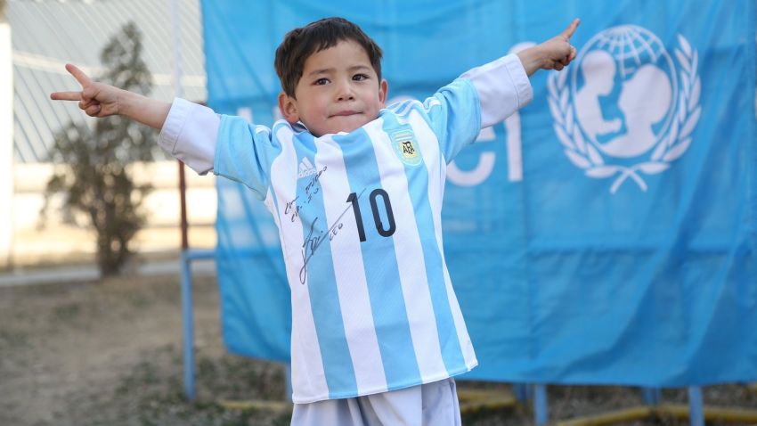 Murtaza Ahmadi is pictured wearing the autographed Lionel Messi Argentina shirt given to him by the soccer superstar and UNICEF.