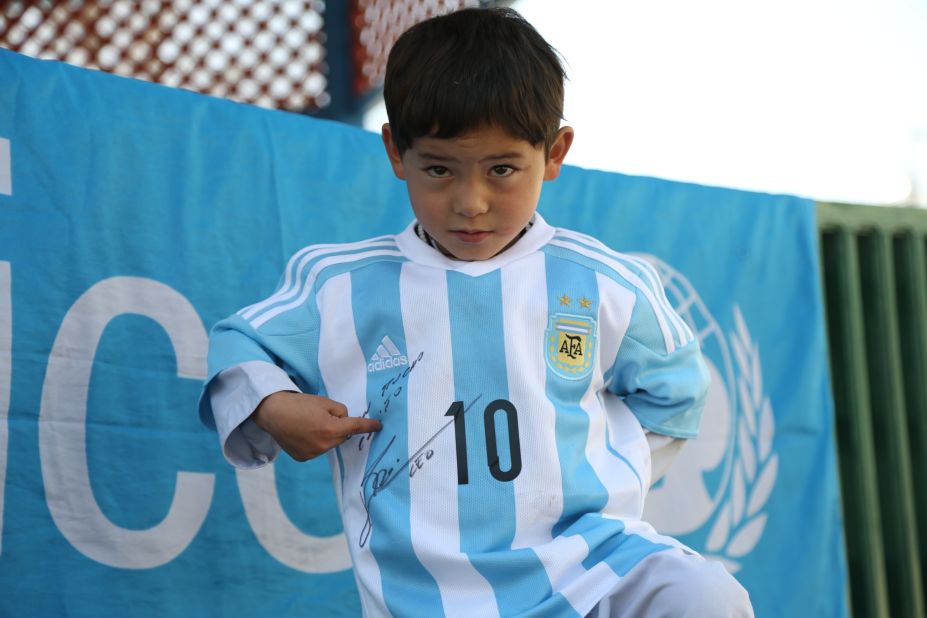 Murtaza points proudly to the dedication and autograph from Messi, who scored twice for Barcelona in their Champions League win over Arsenal in London.