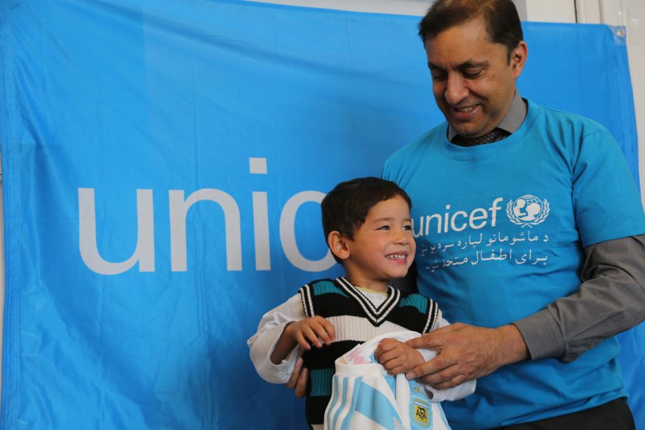 UNICEF Afghanistan representative Akhil Iyer presents the thrilled Murtaza with his gifts from Messi, the Argentine star who plays for Barcelona.