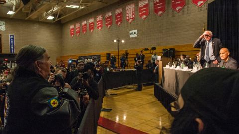 American Indian Movement co-founder, Clyde Bellecourt, left, presses Democratic presidential candidate Sen. Bernie Sanders on Native American issues at a forum on race and economic opportunity on February 12 in Minneapolis, Minnesota.