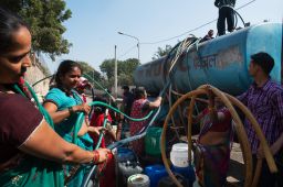 Indian residents remove hoses from a water distribution truck at a distribution point in the low-income eastern New Delhi neighborhood of Sanjay camp on February 23, 2016. 