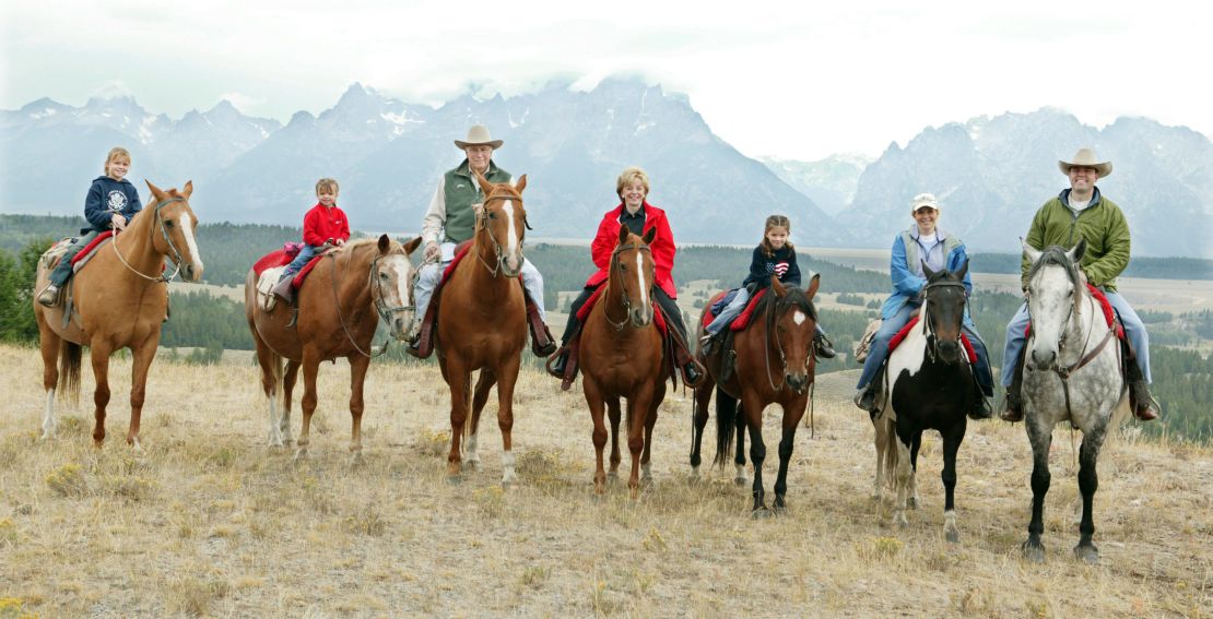 Then-Vice President Dick Cheney with his family: From left to right, granddaughters Katie Perry, 10, Grace Perry, 5, Dick Cheney, Lynne Cheney, granddaughter Elizabeth Perry, 7, daughter Liz Cheney Perry, and son-in-law Phillip Perry August 18, 2004 near Moose, Wyoming.