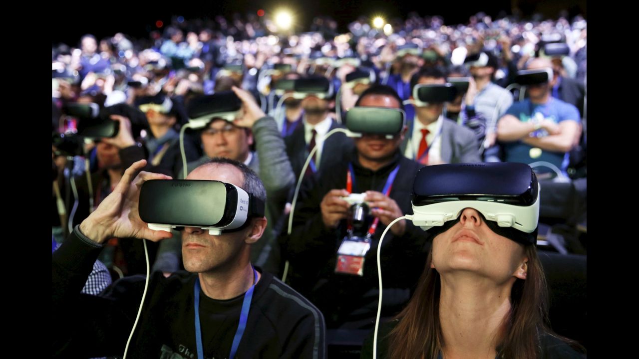 People wear virtual-reality devices made by Samsung as they attend the Mobile World Congress in Barcelona, Spain, on Sunday, February 21.