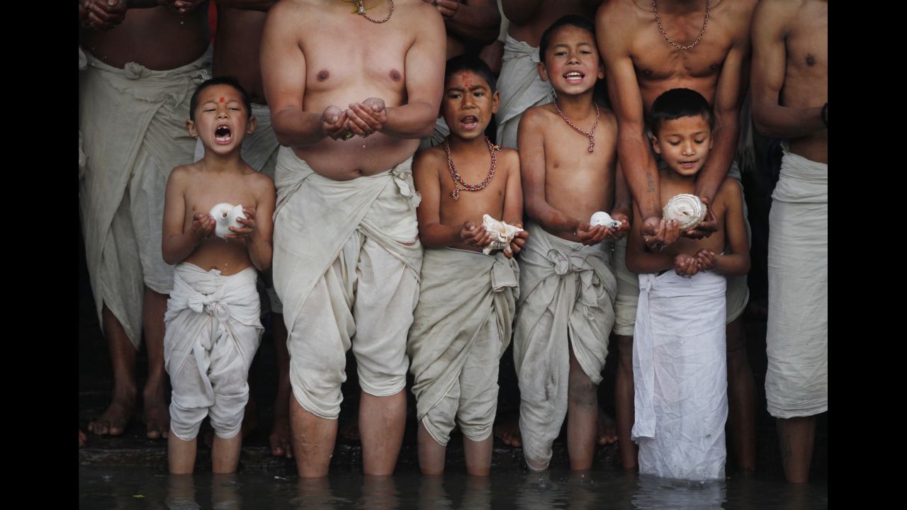 Hindu devotees in Bhaktapur, Nepal, offer a prayer on the bank of Hanumante River during during the Swasthani Brata Katha festival on Monday, February 22.