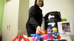 Eileen Walters sorts through some of the toys typically given to soothe children with special needs.