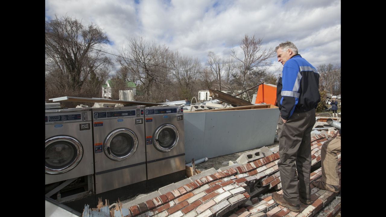 Virginia Gov. Terry McAuliffe surveys tornado damage in Waverly, Virginia, on Thursday, February 25. Residents and rescue crews combed through wreckage left by storms that killed at least eight people and injured scores across several states, officials said. Three died in Waverly.
