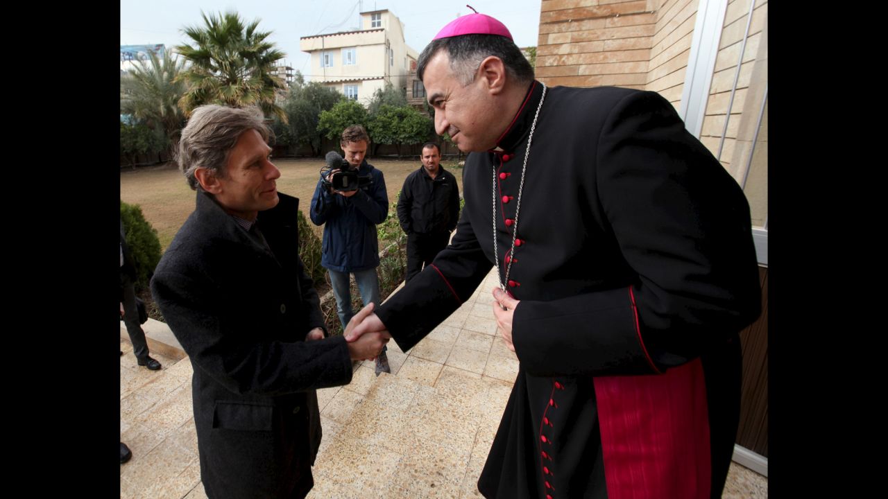 Tom Malinowski, U.S. assistant secretary of state for democracy, human rights and labor, shakes hands with Archbishop Bashar Matti during his visit to the Chaldean Church in Erbil, Iraq, on Tuesday, February 23.