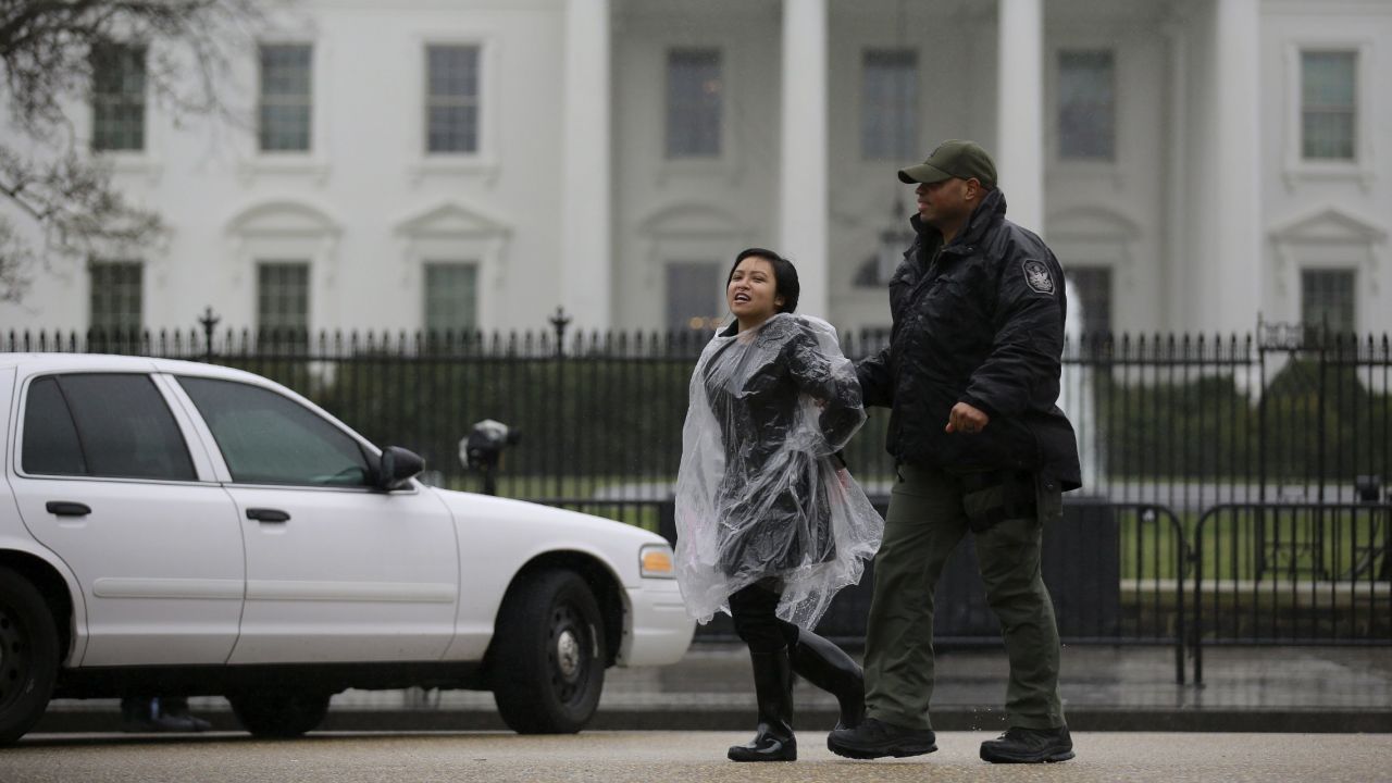 An anti-deportation demonstrator is detained by the police during a protest outside the White House on February 23, 2016.