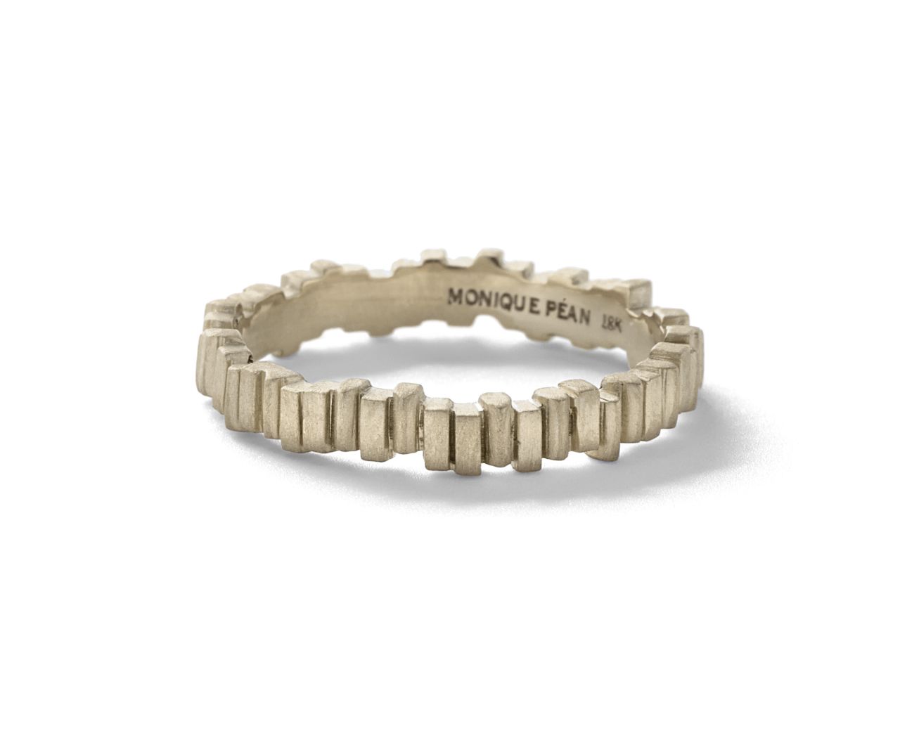 "I would recommend my Norske band as a minimalist engagement ring for men with an appreciation of art and architecture. The design of this ring pays homage to Norwegian construction, and highlights my interest in the graceful juxtaposition of negative space, structure and form. The texture of this ring was specifically influenced by the Oslo Opera House's undulating wall." -- <a href="http://moniquepean.com/" target="_blank" target="_blank">Monique Péan</a>, Designer <br />