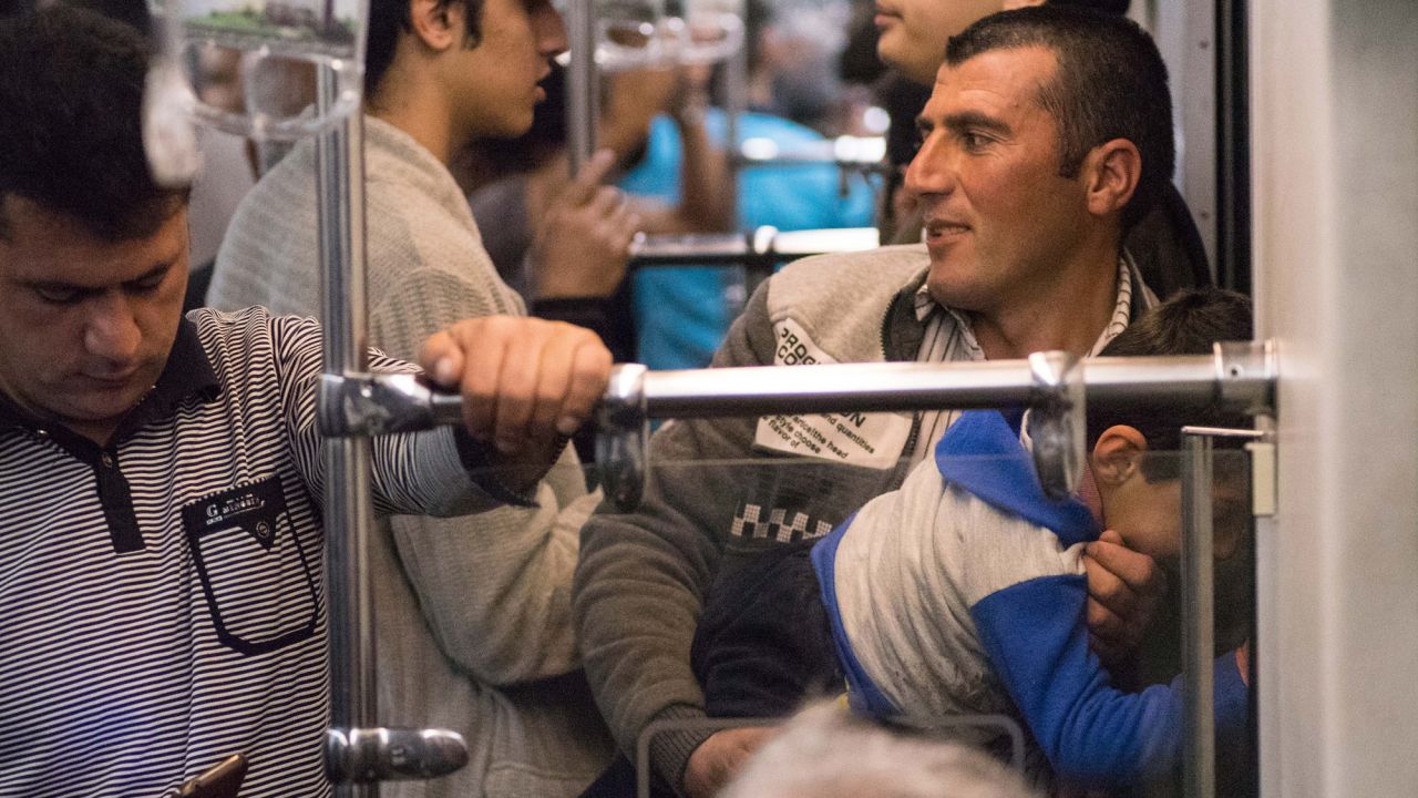 A man and his young son watch the tunnel go by.
