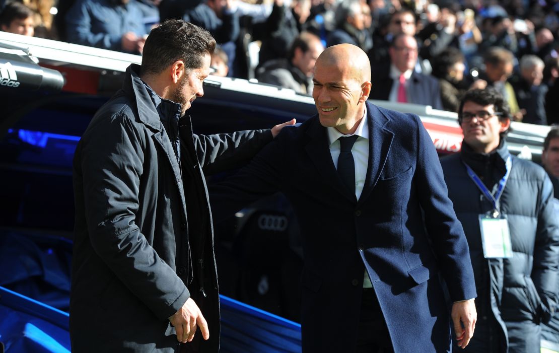 Real Madrid manager, Zinedine Zidane (R), welcomes Atletico Madrid coach, Diego Simeone to the Santiago Bernabeu.