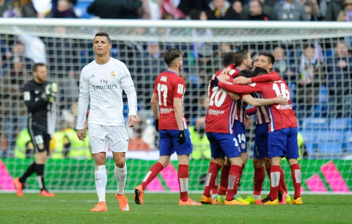 Atletico players celebrate on full time as Ronaldo walks away in frustration.