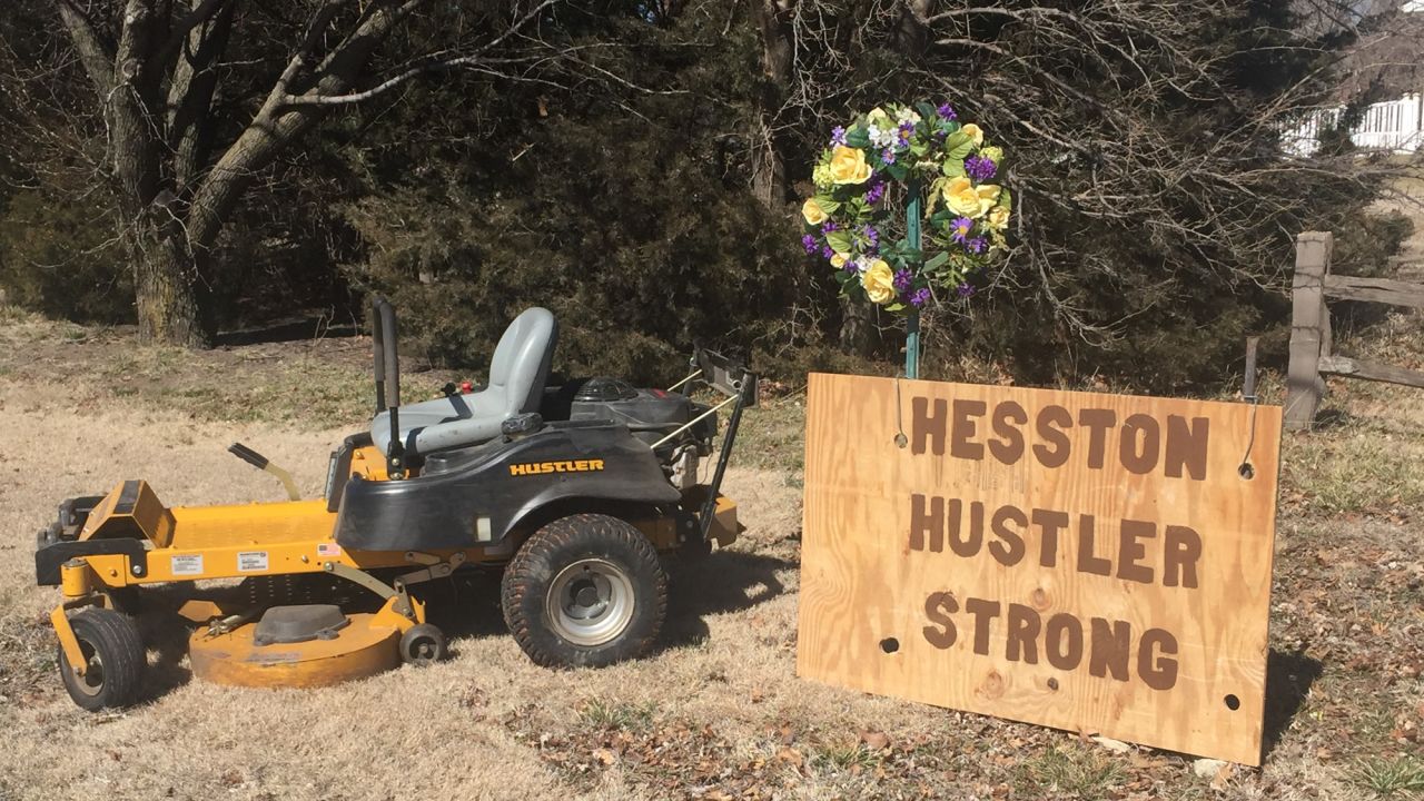 Residents in this Kansas town show solidarity by displaying their lawn mowers with messages of encouragement. The killings happened at a lawn mower factory.