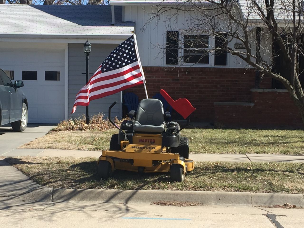 A riding mower and an American flag show a homeowner's support of the victims. "I think I'm just numb, because I haven't had any tears," said Terre Bowlin.