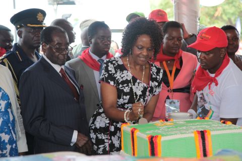 President Mugabe's wife, Grace, helps him cut a birthday cake at celebrations at Masvingo on Saturday, February 27, 2016. The area is one of the worst drought-stricken regions. The lavish festivities surrounding the president's 92nd birthday have drawn criticism as several regions remain in a "state of disaster". <br />