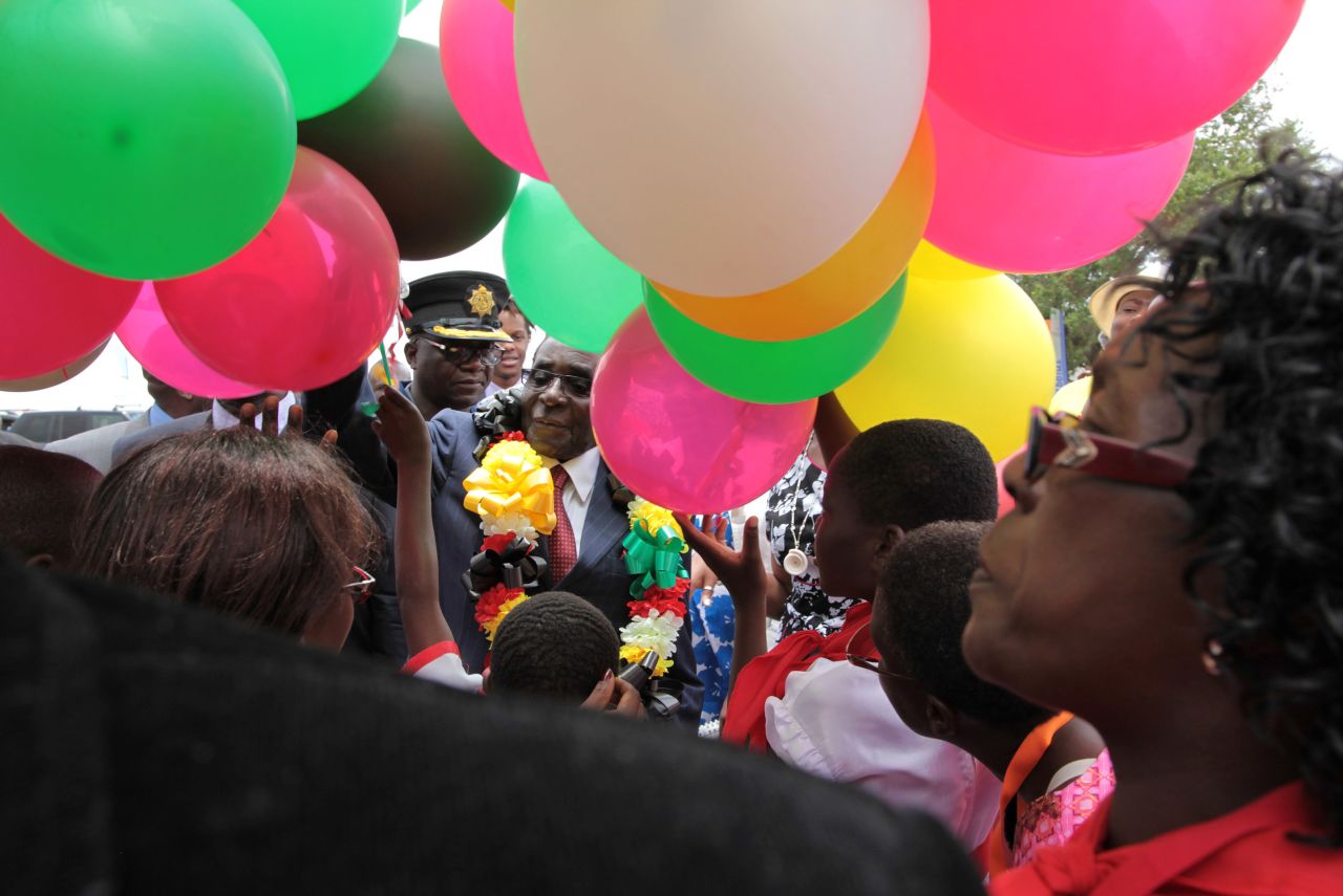 Mugabe is surrounded by a crowd as he prepares to release balloons into the air on February 27, 2016.