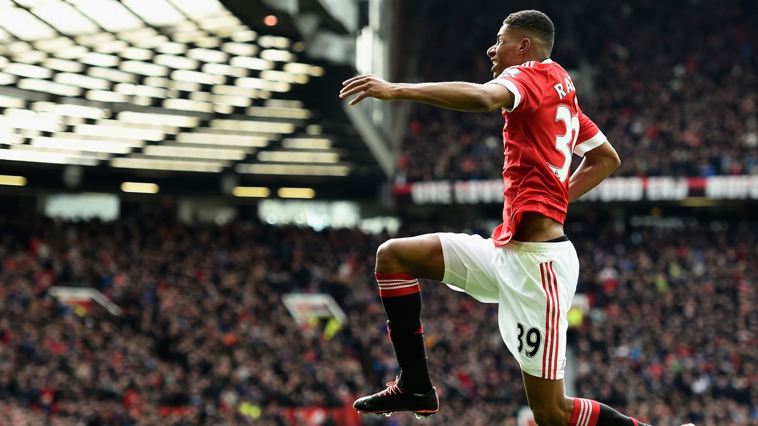 High flyer: Marcus Rashford celebrates scoring the opening goal for Manchester United at Old Trafford.