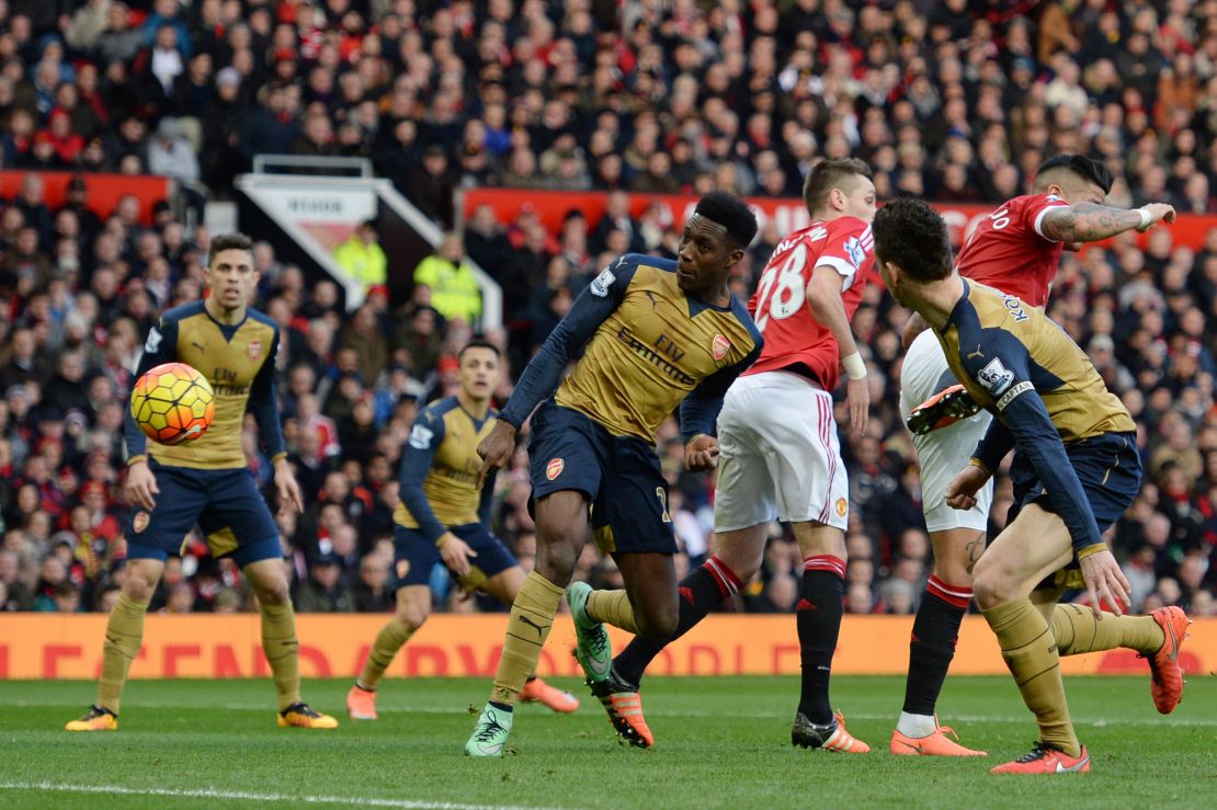 Danny Welbeck carefully steers his header goalwards to pull one back for Arsenal against his former side Manchester United.