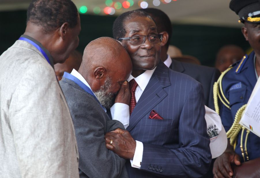 A man cries as he greets him on February 27, 2016. Members of Zimbabwe's ruling party ZANU-PF called the president "Dear Father", "His Royal Highness" and "the Moses of Africa."