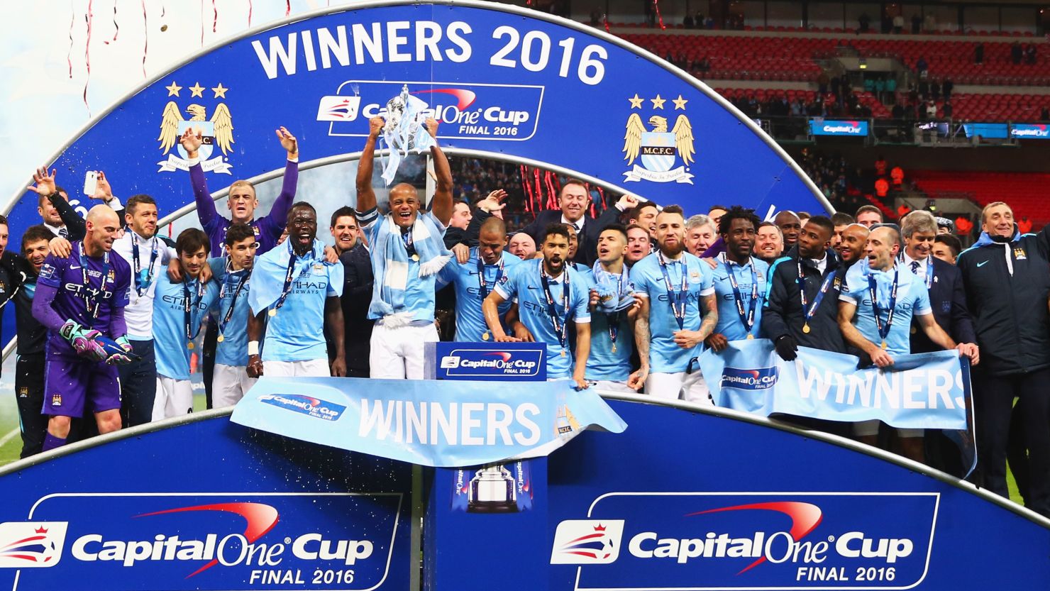 Manchester City captain Vincent Kompany lifts the trophy after his side's penalty shoot out win over Liverpool at Wembley.