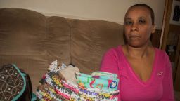 Nakiya Wakes sits with the clothes and supplies she bought in anticipation of a newborn baby. 