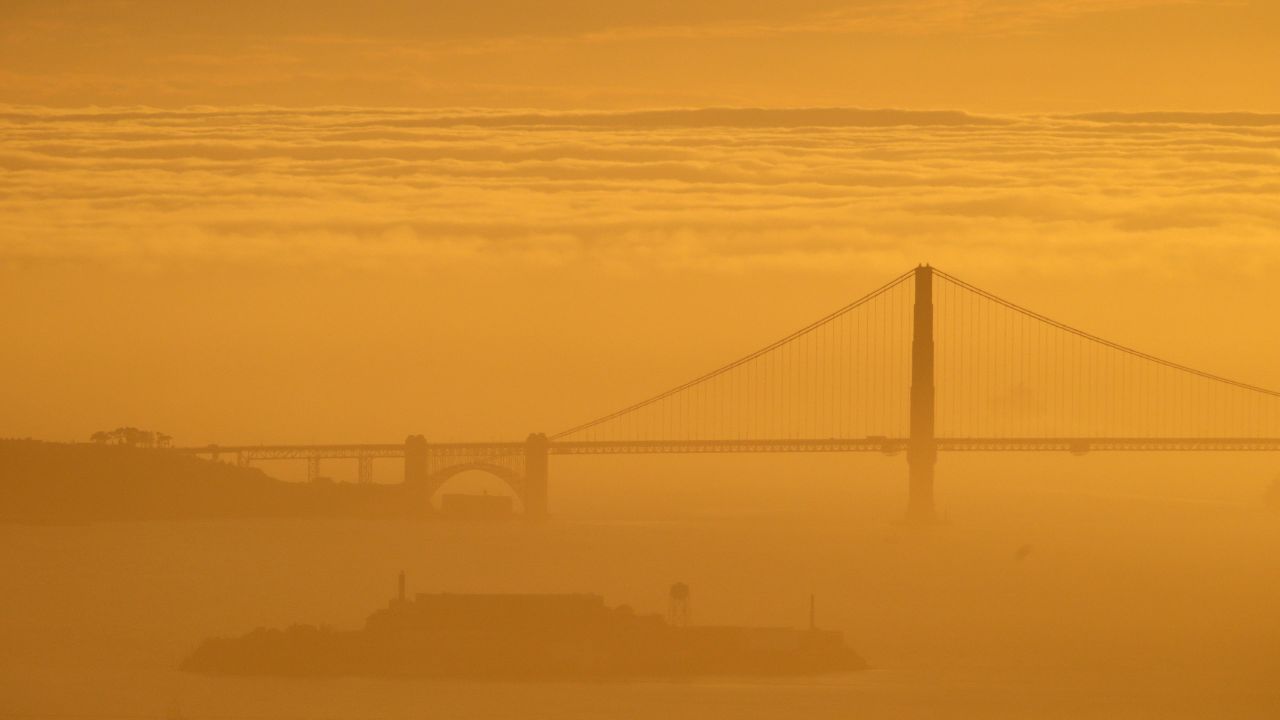 Looking west, the Golden Gate Bridge and Alcatraz Island can be seen across the bay from Berkeley. The bridge links San Francisco to Marin County.