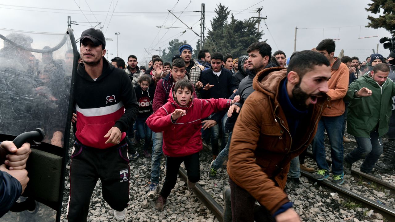 Migrants run after breaking Greek police blockade towards the border fence of Macedonia near the Greek village of Idomeni, on February 29 , 2016.
Macedonian police fired tear gas on February 29, 2016, as a group of some 300 Iraqi and Syrians forced their way through a Greek police cordon and raced towards a railway track between the two countries. With Austria and Balkan states capping the numbers of migrants entering their soil, there has been a swift buildup along the Greece-Macedonia border with Athens warning that the number of people "trapped" could reach up to 70,000 by next month.  