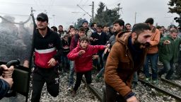 Migrants run after breaking Greek police blockade towards the border fence of Macedonia near the Greek village of Idomeni, on February 29 , 2016.
Macedonian police fired tear gas on February 29, 2016, as a group of some 300 Iraqi and Syrians forced their way through a Greek police cordon and raced towards a railway track between the two countries. With Austria and Balkan states capping the numbers of migrants entering their soil, there has been a swift buildup along the Greece-Macedonia border with Athens warning that the number of people "trapped" could reach up to 70,000 by next month.