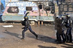 A police officer throws a tear gas canister this week at the "Jungle."