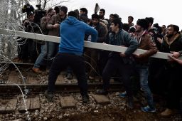 Migrants ram the border fence between Greece and Macedonia at a camp near the village of Greek village of Idomeni.