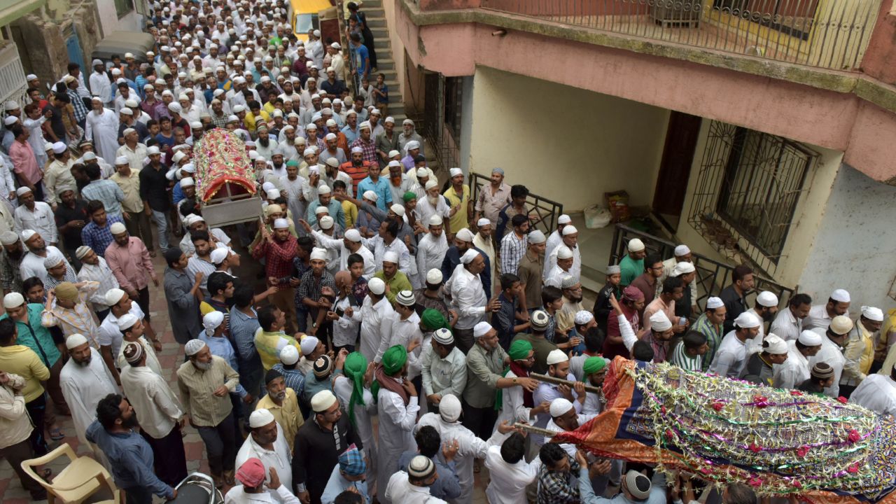 Indian mourners bear the coffins of some of the 14 family members murdered in Thane during their funeral Sunday.