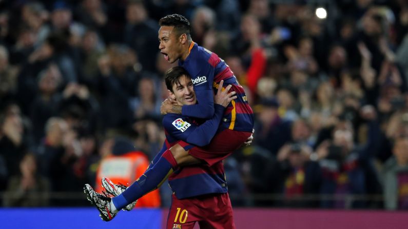 Lionel Messi holds his Barcelona teammate, Neymar, after scoring against Sevilla on Sunday, February 28. It was Messi's 30th goal of the season for Barcelona, which took an eight-point lead in the Spanish league.