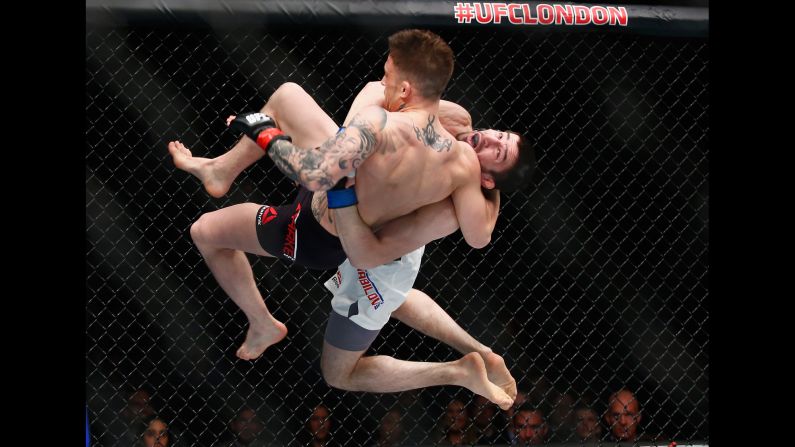 Rustam Khabilov (black shorts) throws Norman Parke during a UFC bout in London on Saturday, February 27. Khabilov won by unanimous decision.