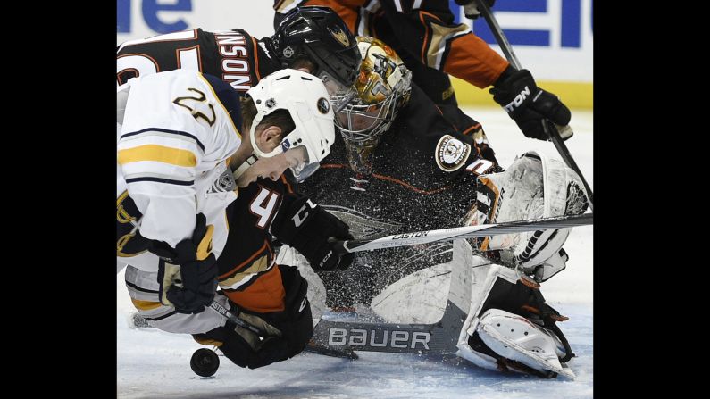 Anaheim goalie Frederik Andersen makes a save Wednesday, February 24, as teammate Josh Manson battles Buffalo's Johan Larsson in the crease.