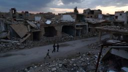 Syrian children walk past heavily damaged buildings in the rebel-held town of Douma, on the eastern edges of the capital Damascus on February 27, 2016, on the first day of the landmark ceasefire agreement. 
Less than a day into a landmark ceasefire deal in parts of the country, residents say their usual routine has been thrown off without the usual sounds of artillery, rocket attacks, or helicopter-borne barrel bombs.

 / AFP / Sameer Al-Doumy        (Photo credit should read SAMEER AL-DOUMY/AFP/Getty Images)