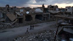 Syrian children walk past heavily damaged buildings in the rebel-held town of Douma, on the eastern edges of the capital Damascus on February 27, 2016, on the first day of the landmark ceasefire agreement.
Less than a day into a landmark ceasefire deal in parts of the country, residents say their usual routine has been thrown off without the usual sounds of artillery, rocket attacks, or helicopter-borne barrel bombs.
/ AFP / Sameer Al-Doumy (Photo credit should read SAMEER AL-DOUMY/AFP/Getty Images)