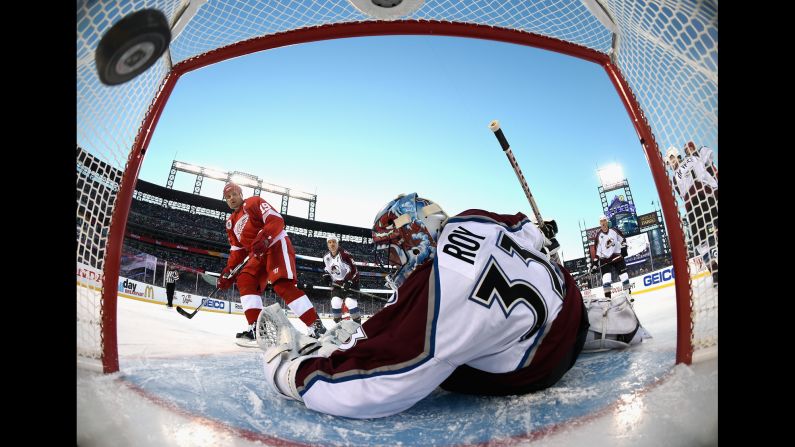 Detroit legend Steve Yzerman, left, scores against Colorado great Patrick Roy during an NHL alumni game in Denver on Friday, February 26. The game was played at Coors Field, the home of Major League Baseball's Colorado Rockies. Roy is now the head coach of the Colorado Avalanche. Yzerman is general manager of the Tampa Bay Lightning.