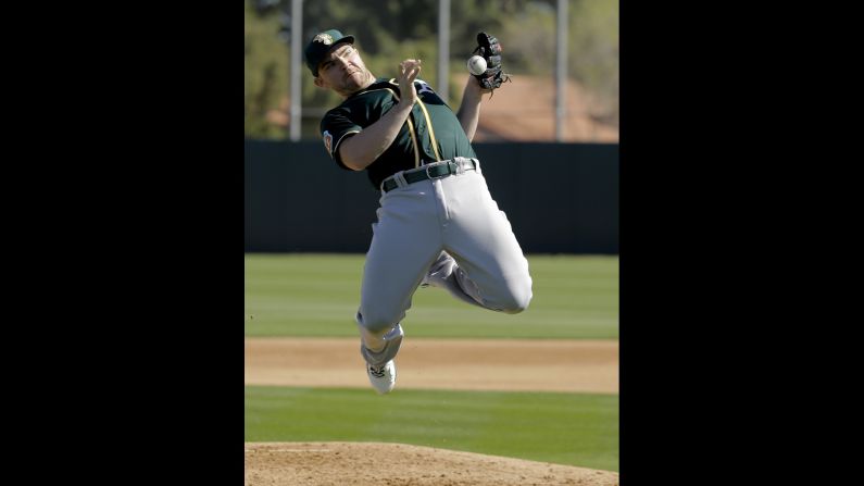 Oakland pitcher Liam Hendriks catches a ball during spring training drills in Mesa, Arizona, on Thursday, February 25.