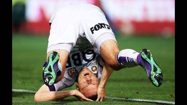 Chris Harold, a soccer player with the Perth Glory, falls over as he reacts to a missed opportunity Friday, February 26, in Sydney.