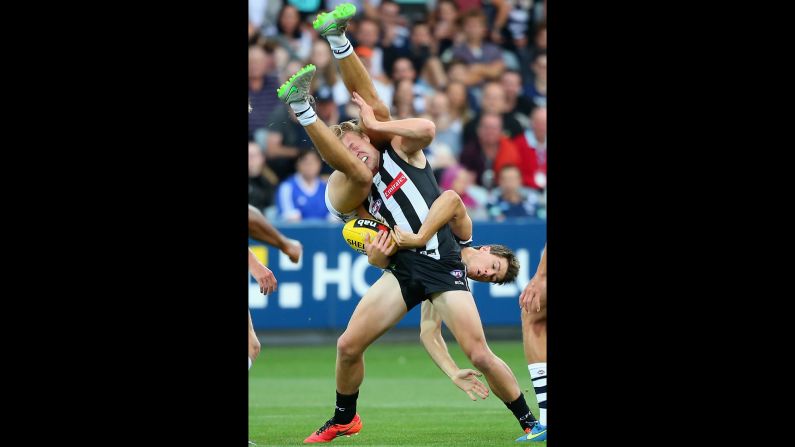 Jordan de Goey of the Collingwood Magpies is tackled by Andrew Mackie of the Geelong Cats during an Australian rules football match on Friday, February 26.