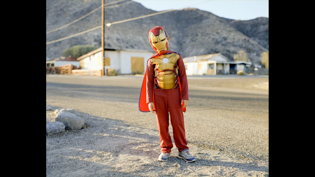 A boy wears an Iron Man costume.
